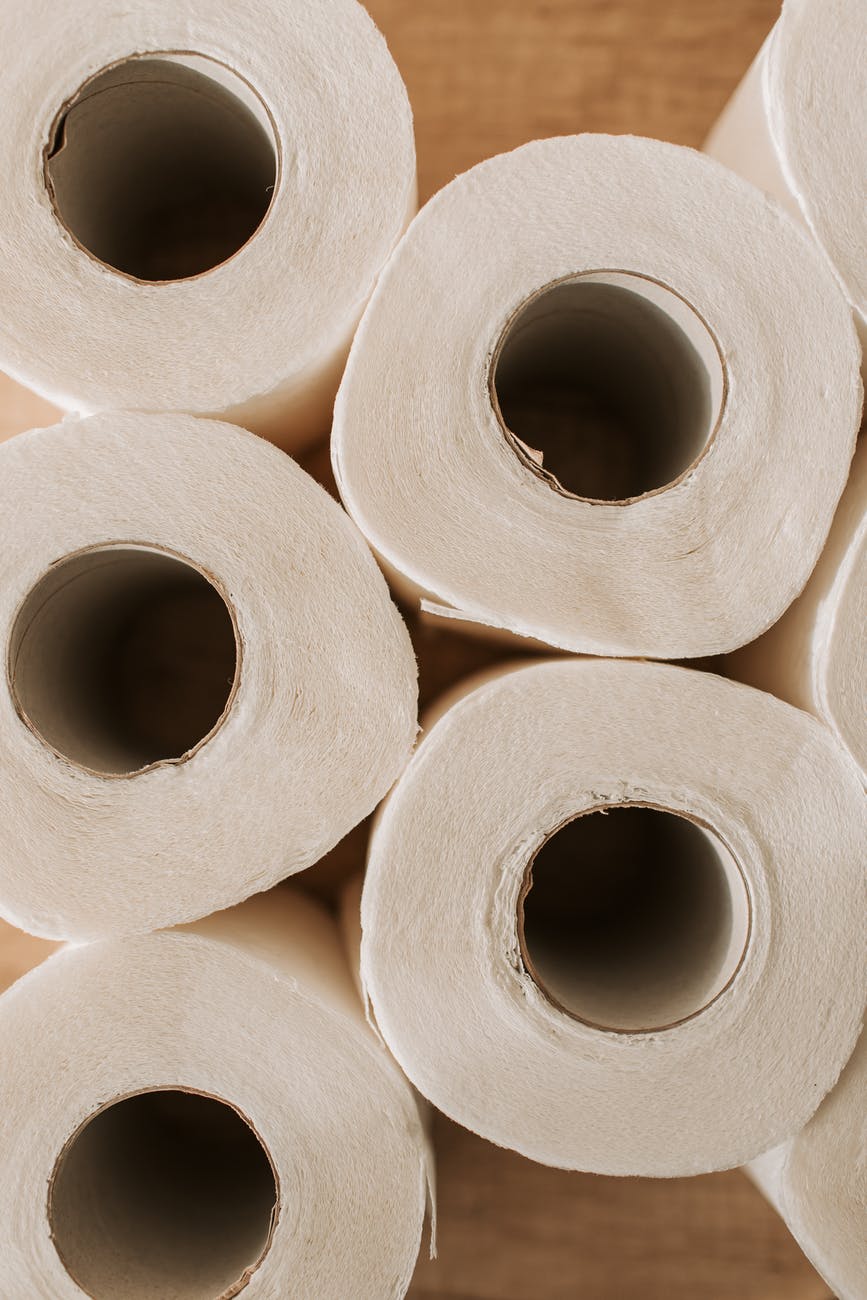 set of toilet paper on wooden background