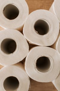 set of toilet paper on wooden background
